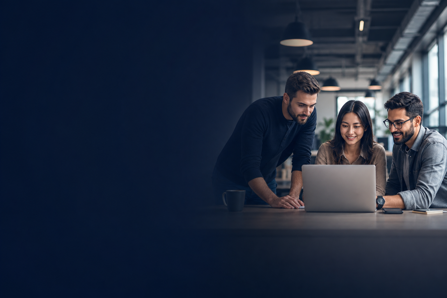 Software specialists collaborating around a laptop